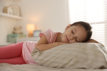 Cute girl sleeping in bed at home. Space for text