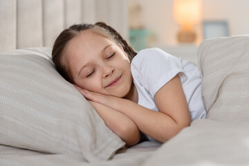 Cute girl sleeping in bed at home
