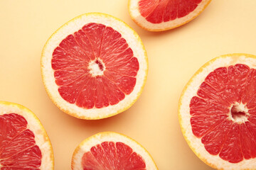Fresh raw grapefruit on beige background. Space for text