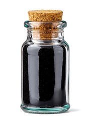 A small glass bottle with a cork top filled with a black substance