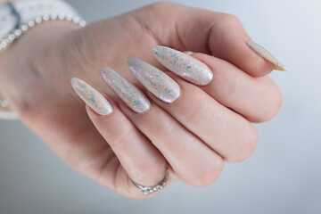beautiful female hands with long nails light white manicure