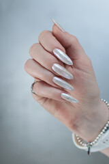 beautiful female hands with long nails light white manicure