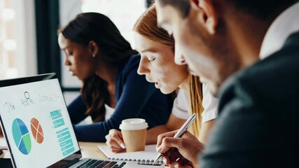 Business team analyzing financial data on laptop in modern office - Powered by Adobe
