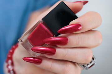 Female hands with long nails and red nail polish