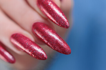 Female hands with long nails and red nail polish