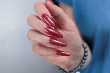 Female hands with long nails and red nail polish