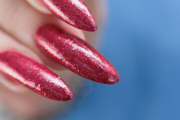 Female hands with long nails and red nail polish