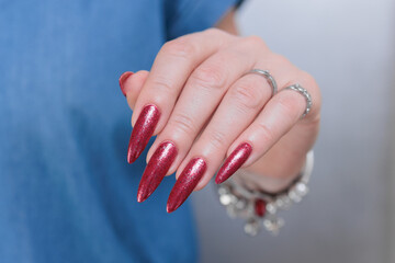 Female hands with long nails and red nail polish