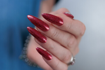 Female hands with long nails and red nail polish