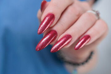 Female hands with long nails and red nail polish