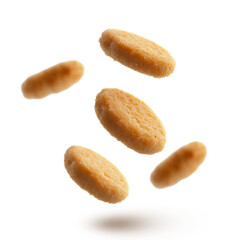 Obraz premium Flying chicken nuggets isolated on white background. Crispy golden brown chicken nuggets falling isolated. Fresh fried chicken nuggets floating.