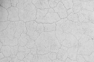 Abstract pattern of cracks on a white concrete wall surface, background