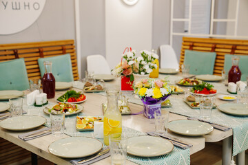 A served festive table with snacks, dishes and drinks.