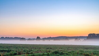 Fototapeta premium Sunrise action over misty landscape tranquil field nature photography rural environment serene perspective morning light