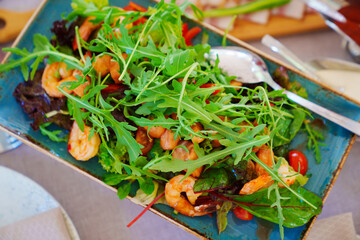 Arugula salad with fried shrimp.