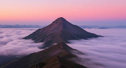 Fototapeta premium Mountain Peak Above Clouds at Sunset with Pink Sky