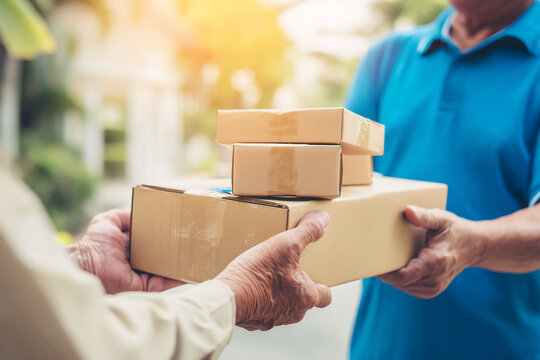 Close-up of hands exchanging cardboard boxes, showcasing a delivery service or online shopping concept.  Represents safe and reliable package handling