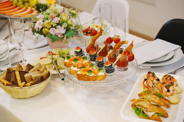  A served festive table with a variety of appetizers and flowers.