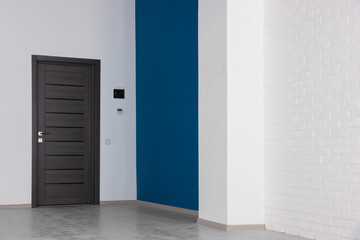 Empty office room with color walls and black door. Interior design