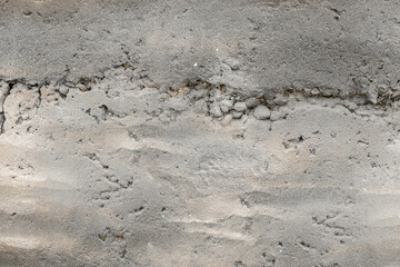 A stained cracked cement wall surface texture closeup