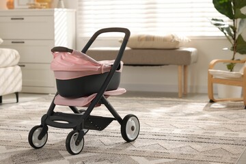 Doll stroller in room, space for text. Kid's toy
