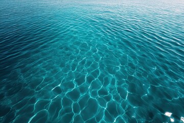 Fototapeta premium Aerial view of turquoise water surface with sun reflections and small waves