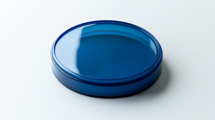 Isolated view of a blue plastic round jar lid on a clean white backdrop