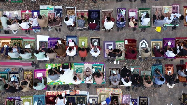 overhead shot capturing the spiritual atmosphere of the Eid prayer gathering under the morning sky.