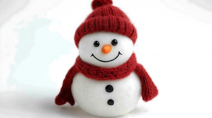 Cheerful snowman in red knit hat and scarf