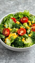 Vibrant garden salad tossed in a white bowl on textured gray stone