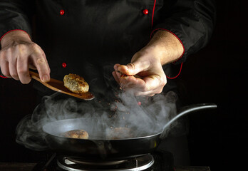 A chef skillfully cooks meatballs in a pan, adding spices to enhance flavor, surrounded by swirling...