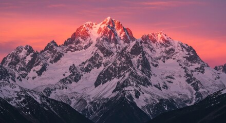 Obraz premium Majestic snow-capped mountain range bathed in the warm hues of the sunrise, creating a stunning alpine landscape. Unforgettable nature.