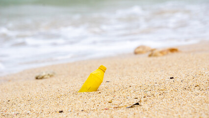 Plastic waste at the beach. Ecological problem. Bokeh moving waves in the background