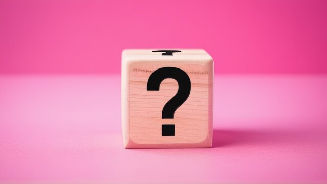 Wooden cube with black question mark on pink background symbolizing uncertainty and curiosity. - Powered by Adobe