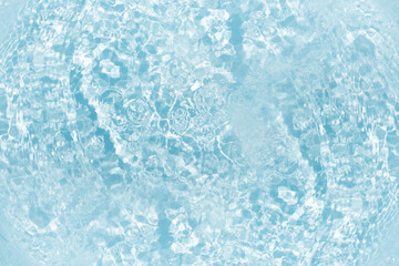 Blue water with ripples on the surface. Defocus blurred transparent blue colored clear calm water surface texture with splashes and bubbles. Water waves with shining pattern texture background.