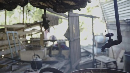 A traditional Laotian rice whiskey machine, locally produced spirits. 4k video footage