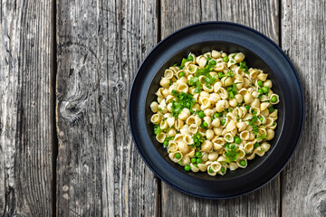 Pasta with green peas in a bowl, italian cuisine