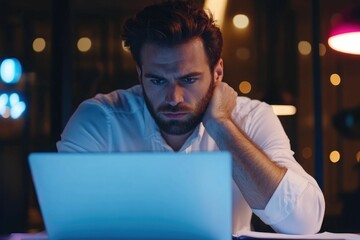 Serious and confident male businessman using laptop computer, taking notes. Work project in modern office. 25 year old male. Finance man working with documents in office. Successful business