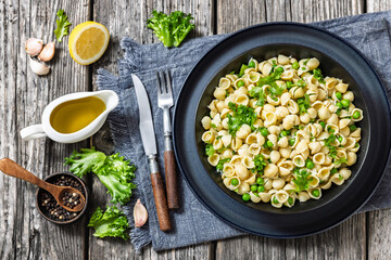 Pasta with green peas in a bowl, italian cuisine