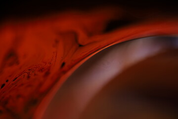 Red fluid reflections on black background, liquid surface abstraction, colour edge, deep dark...