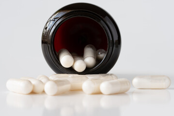 Probiotic Supplement Capsules Spilled from a Bottle