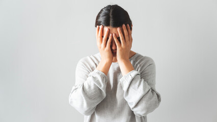 Regretful woman holds her head with her hands