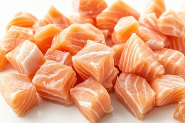 Top view of diced pink salmon pieces on white background, shallow depth of field, ample copy space, isolated, ideal for food design and print uses.