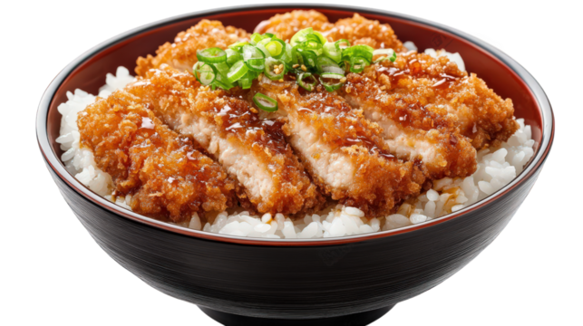 bowl of rice topped with crispy fried chicken cutlets. garnished with green onions and drizzled with a savory sauce this dish is a popular meal option. often enjoyed for its rich flavors and satisfyin