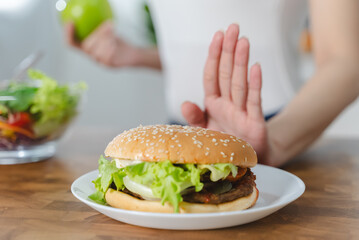Women avoid fast food during diet sessions to lose weight and choose healthy food that has vitamins and nutrition.