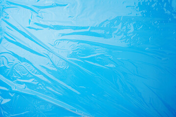 Naklejka premium Transparent stretch film for packaging on a blue background.