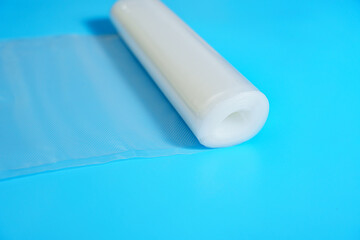 Roll film for a product vacuum sealer machine on a blue background.