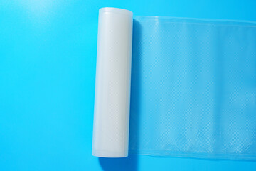 Roll film for a product vacuum sealer machine on a blue background.