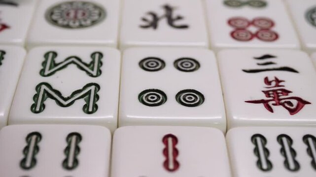 Close-up of Mahjong tile set,Mahjong is a tile-based game from 19th-century China that has gained global popularity since the early 20th century,4k,slow-motion,truck camera movements