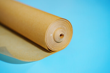 A roll of baking paper on a blue background.